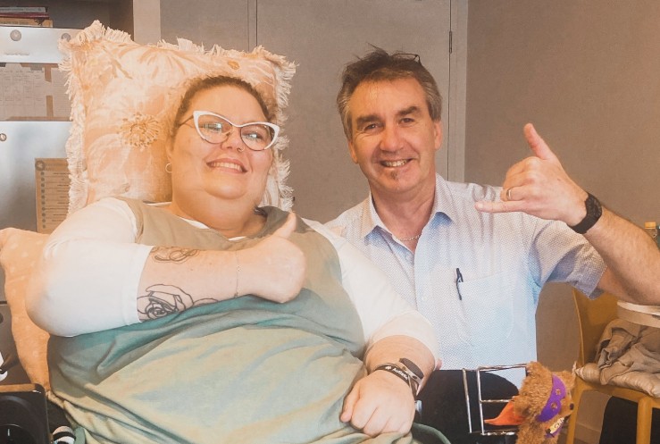 A disability support worker assisting a successful SDA funding applicant